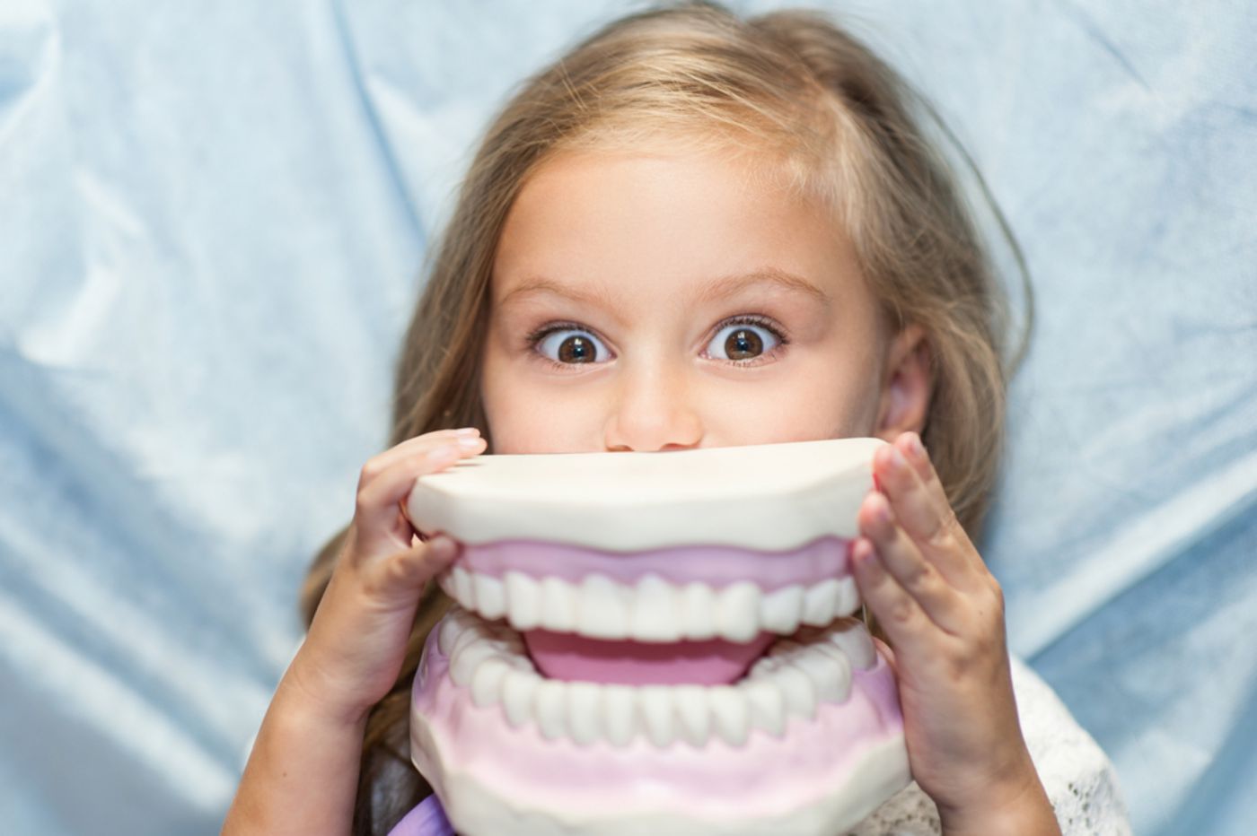 girl-holding-dental-mouth-sample