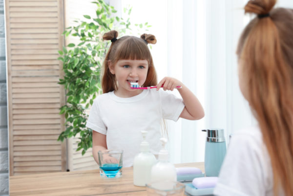 kid uses mouthwash